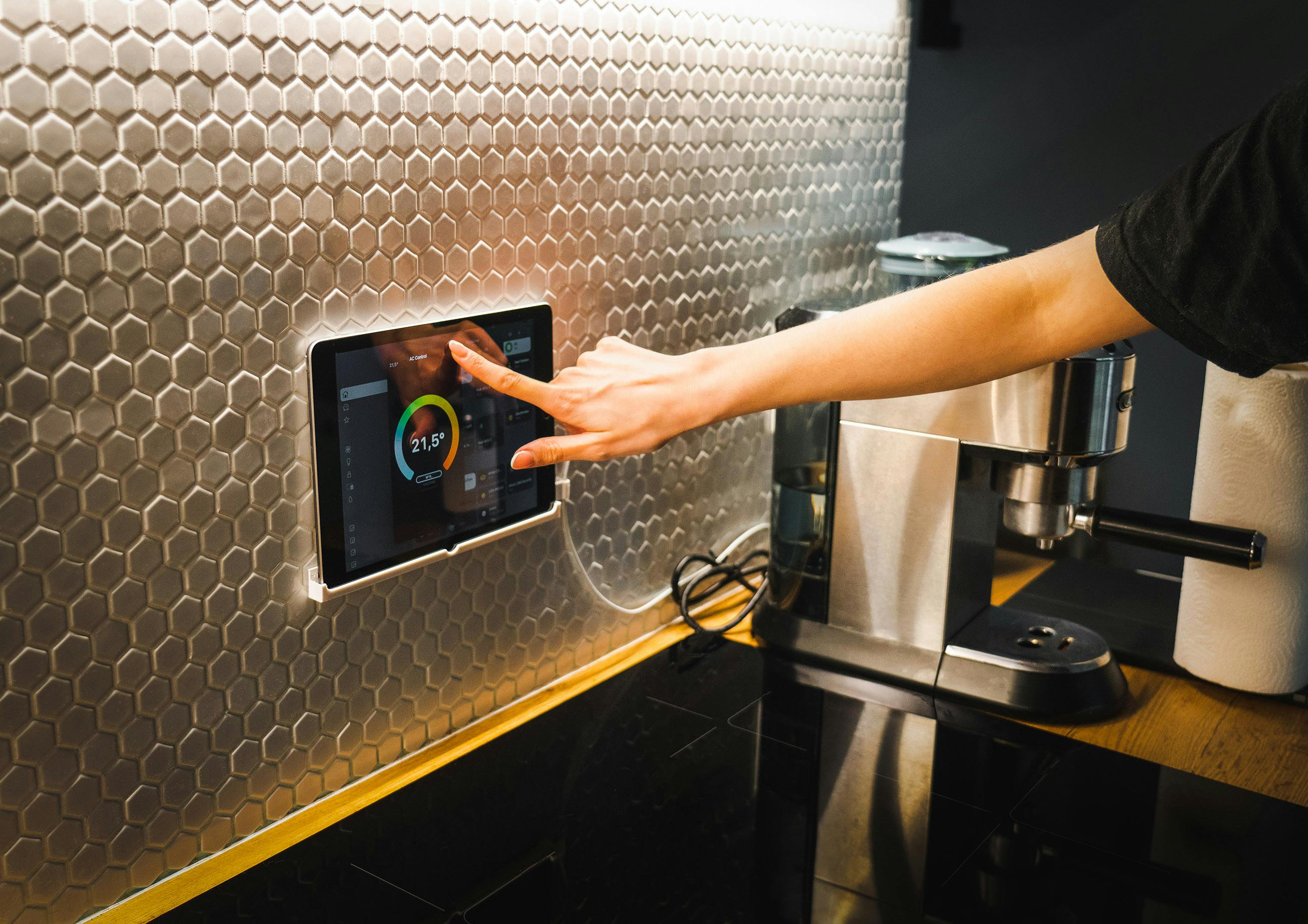 Foto di una mano che regola un monitor di controllo Smart